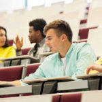 Students engaged in small group discussion in a lecture hall
