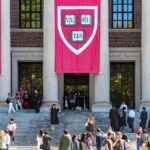 Widener Memorial Library at Harvard University, with Veritas banners hanging and throngs of students on the steps