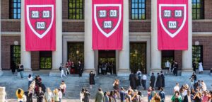 Widener Memorial Library at Harvard University, with Veritas banners hanging and throngs of students on the steps